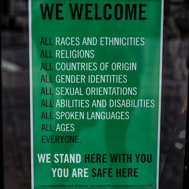 A photograph of a sign espousing diversity that emphasizes 'we stand here with you - you are safe here'